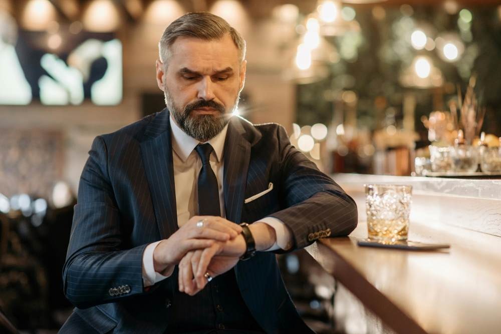 A Man Sitting at the Bar Counter