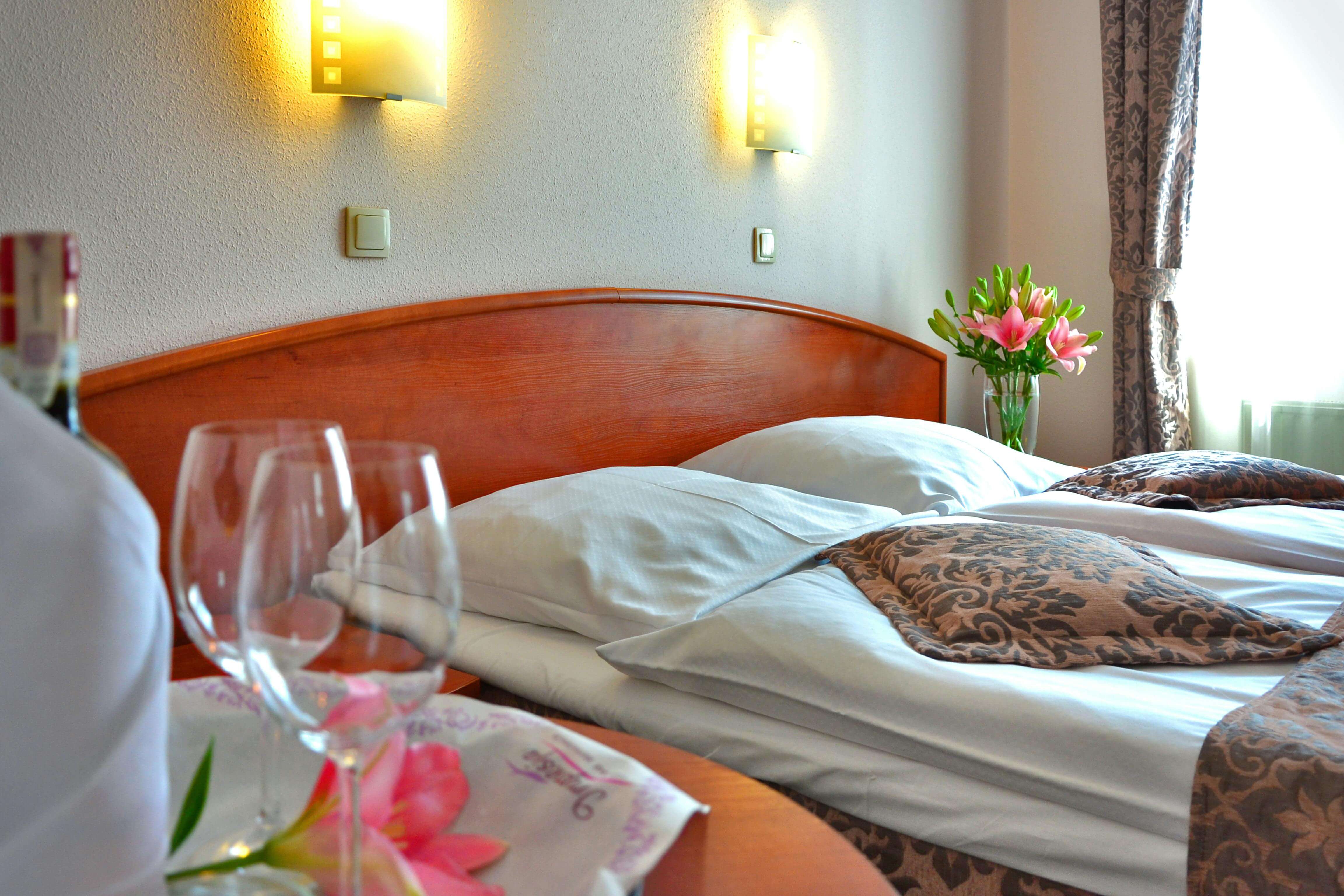 a luxury hotel room with a waiter carrying two glasses