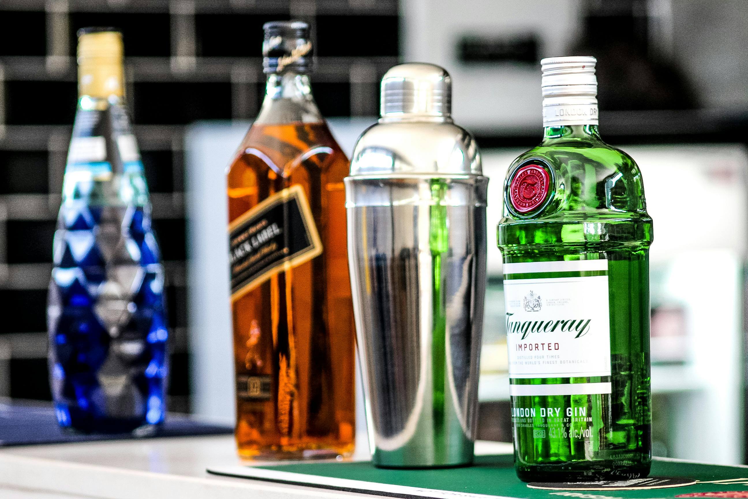 a selection of drinks and a cocktail shaker