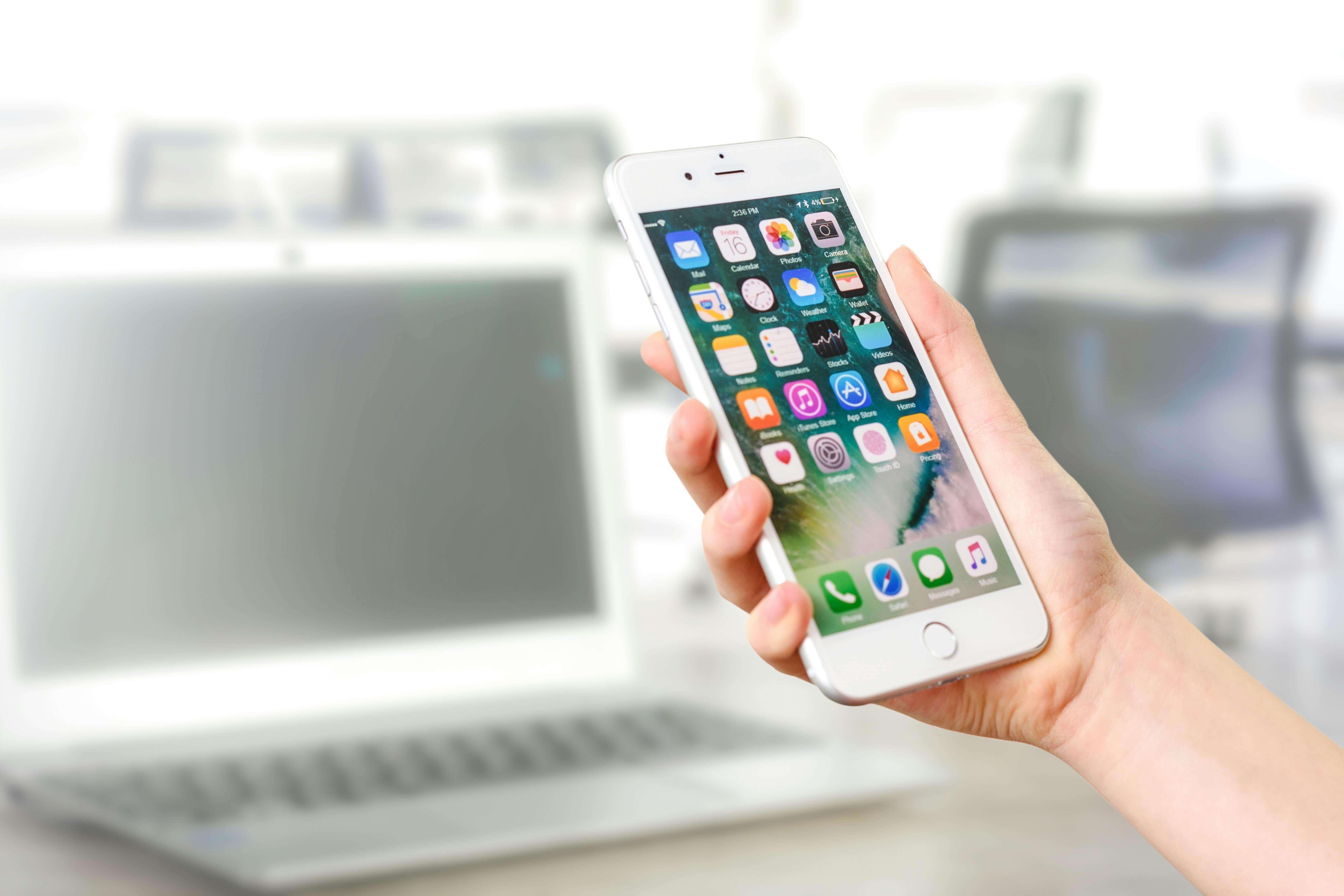 a person holding a smartphone with dating apps on it
