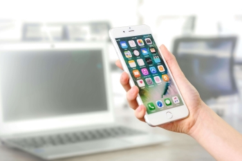 a person holding a smartphone with dating apps on it