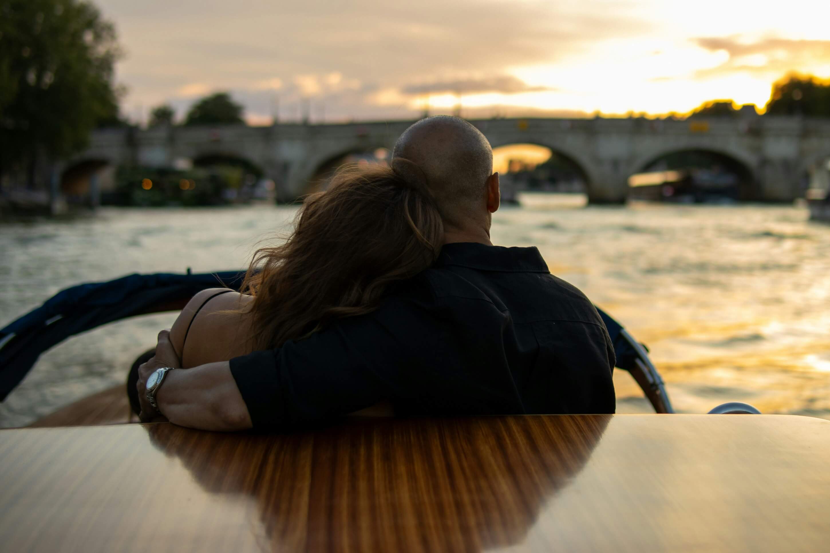 a man and a woman hugging on a boat ride