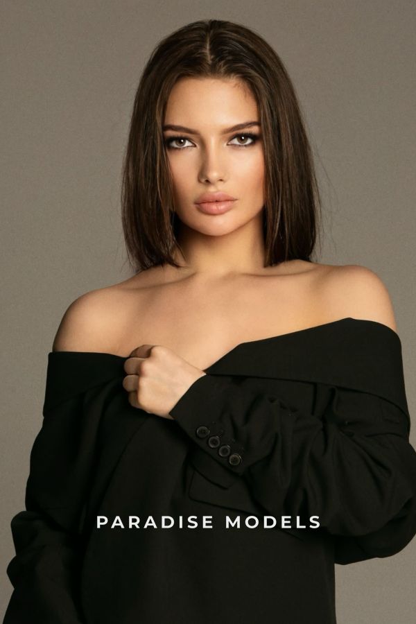 Irina with a black top on, shoulders exposed. 