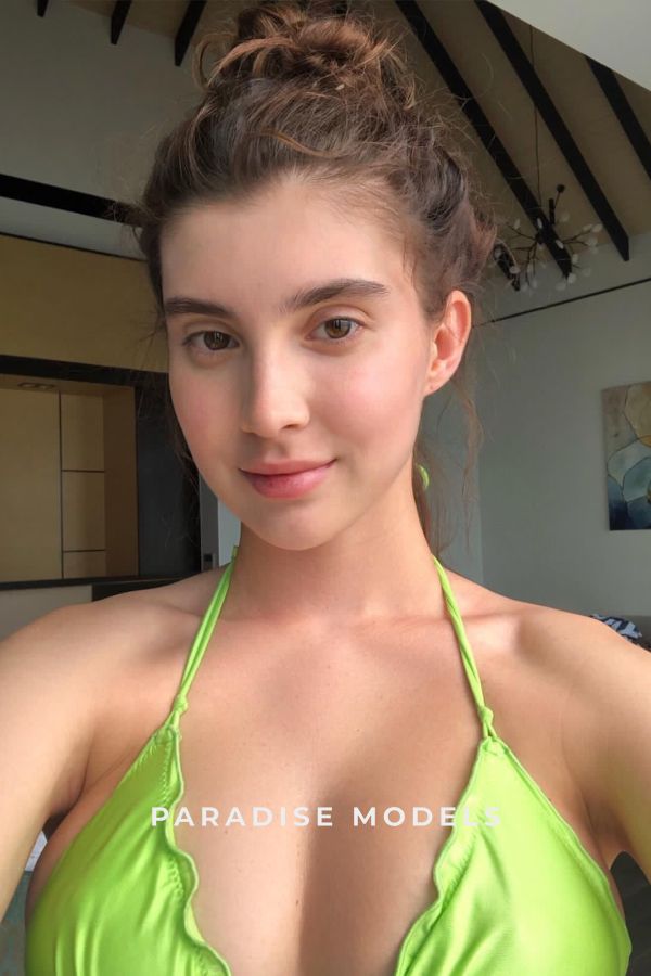Anessa taking a selfie in a green bikini 
