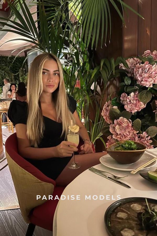 Aira sitting in a restaurant enjoying a drink 